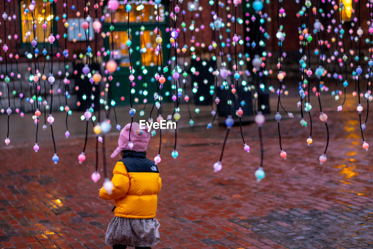 FULL LENGTH OF CHILD STANDING AT ILLUMINATED NIGHT