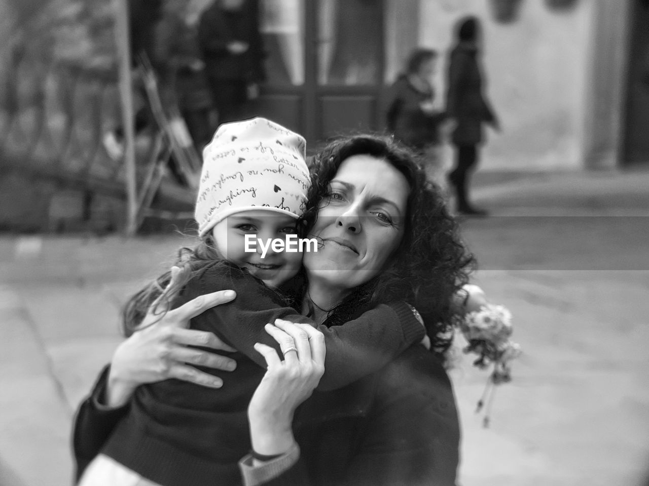 Portrait of girl embracing mother