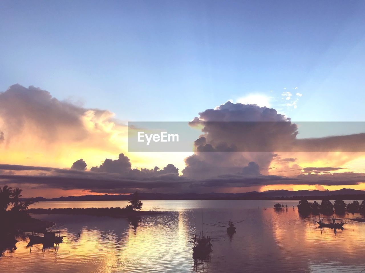 SCENIC VIEW OF SWIMMING POOL AGAINST SKY DURING SUNSET