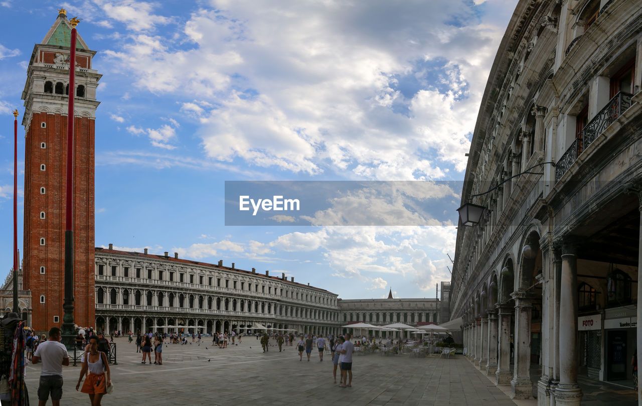 Group of people in front of historical building against sky