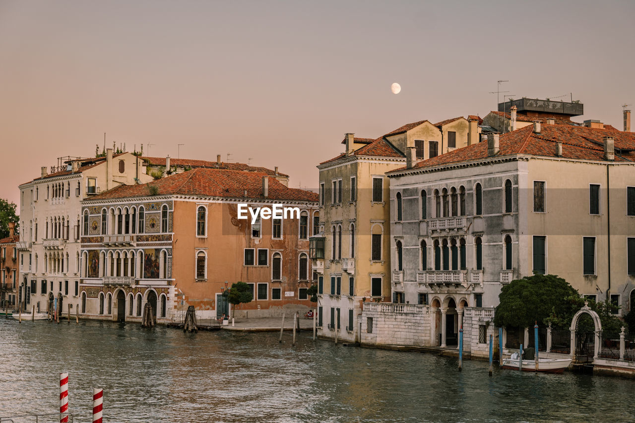 Beautiful evening sunset in venice, italy. moon visible in the sky.
