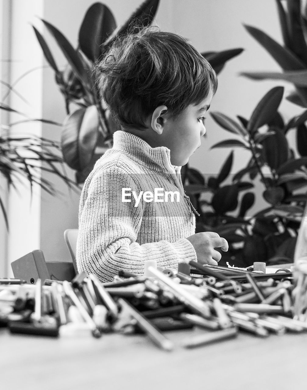 High angle view of boys and color crayons 