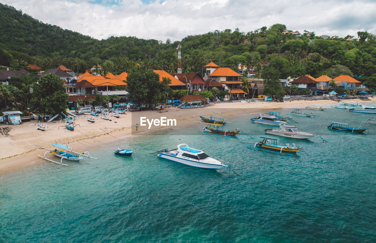 High angle view of buildings by sea against sky