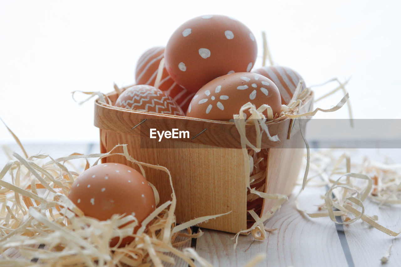 High angle view of easter eggs in basket on table