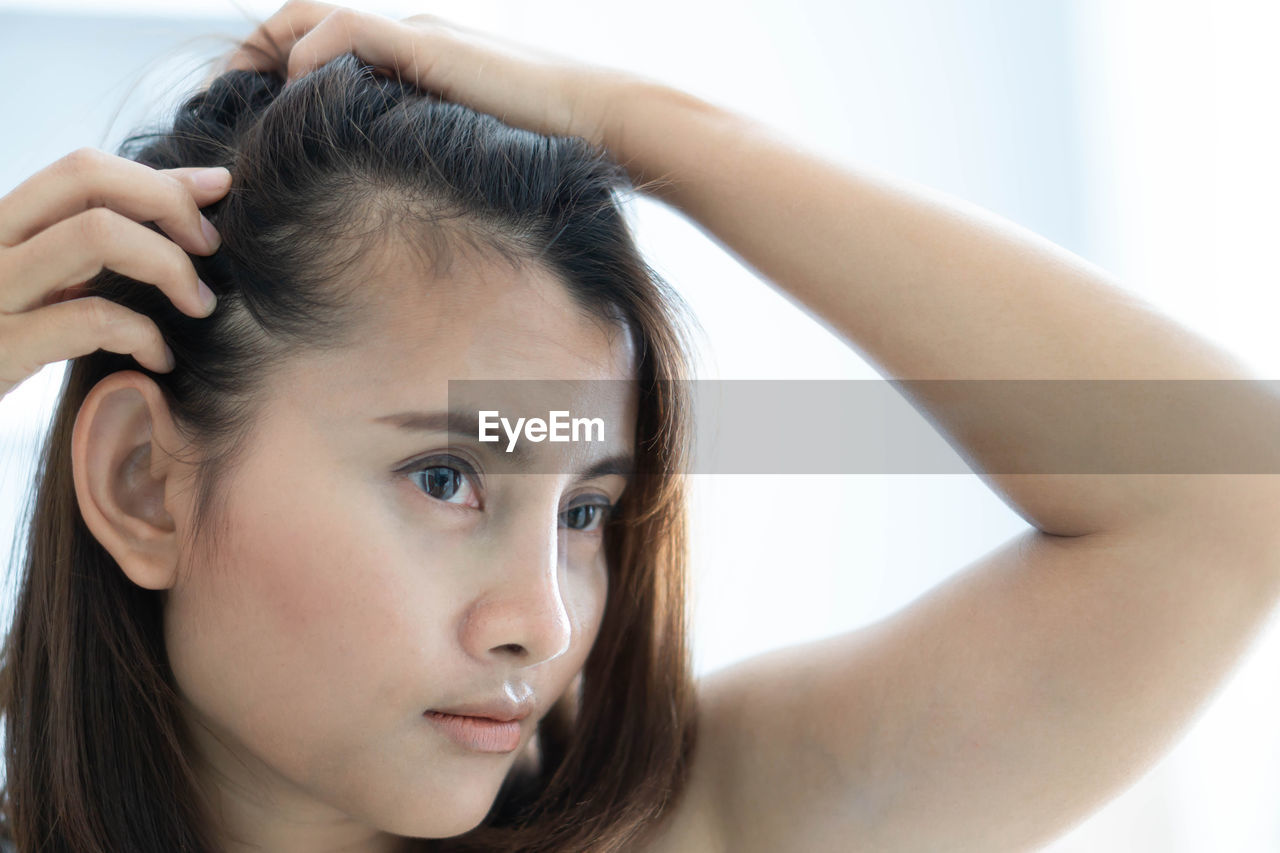 Close-up of woman with hair loss problem