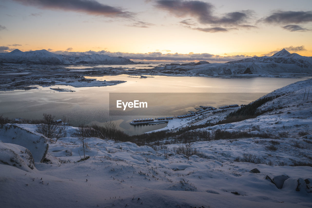 Scenic view of snow covered mountains against sky during sunset