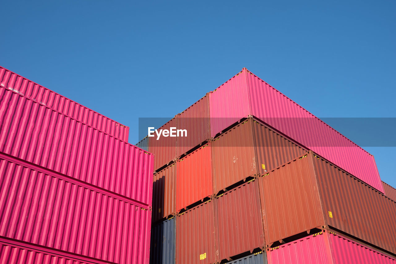 LOW ANGLE VIEW OF PINK BUILDING AGAINST BLUE SKY