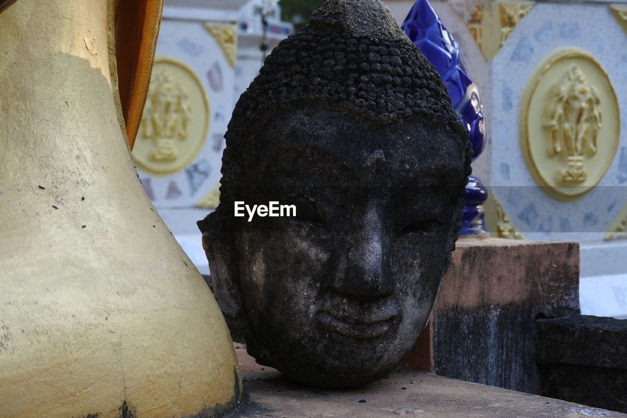 CLOSE-UP OF BUDDHA STATUE