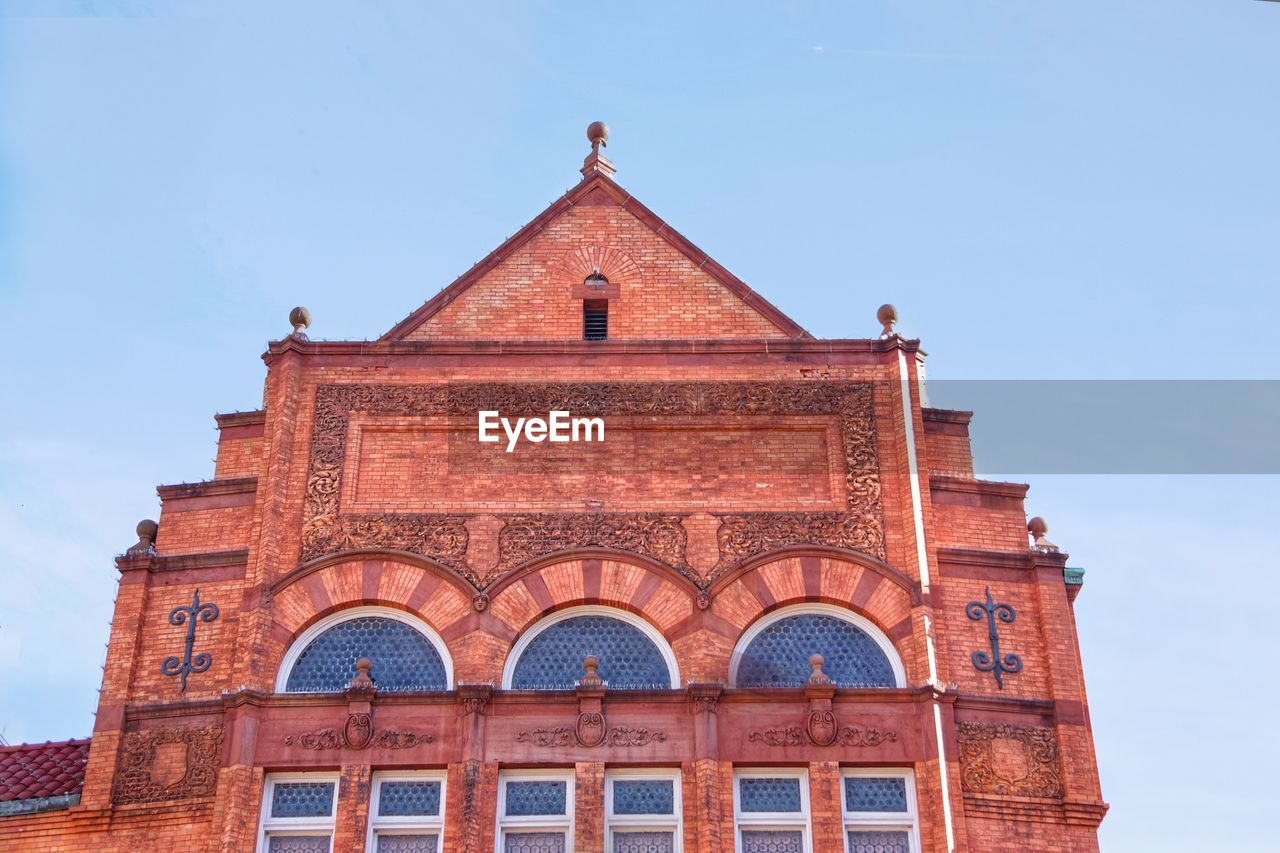 architecture, built structure, building exterior, landmark, sky, building, history, nature, travel destinations, the past, facade, brick, tower, no people, blue, place of worship, arch, religion, day, city, red, travel, outdoors, low angle view, window, clear sky, sunny, belief, tourism