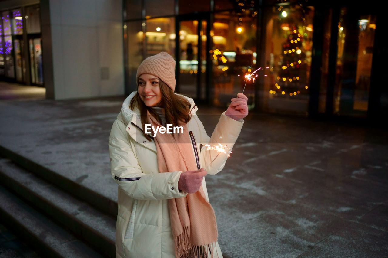 Caucasian white girl with sparklers christmas shopping