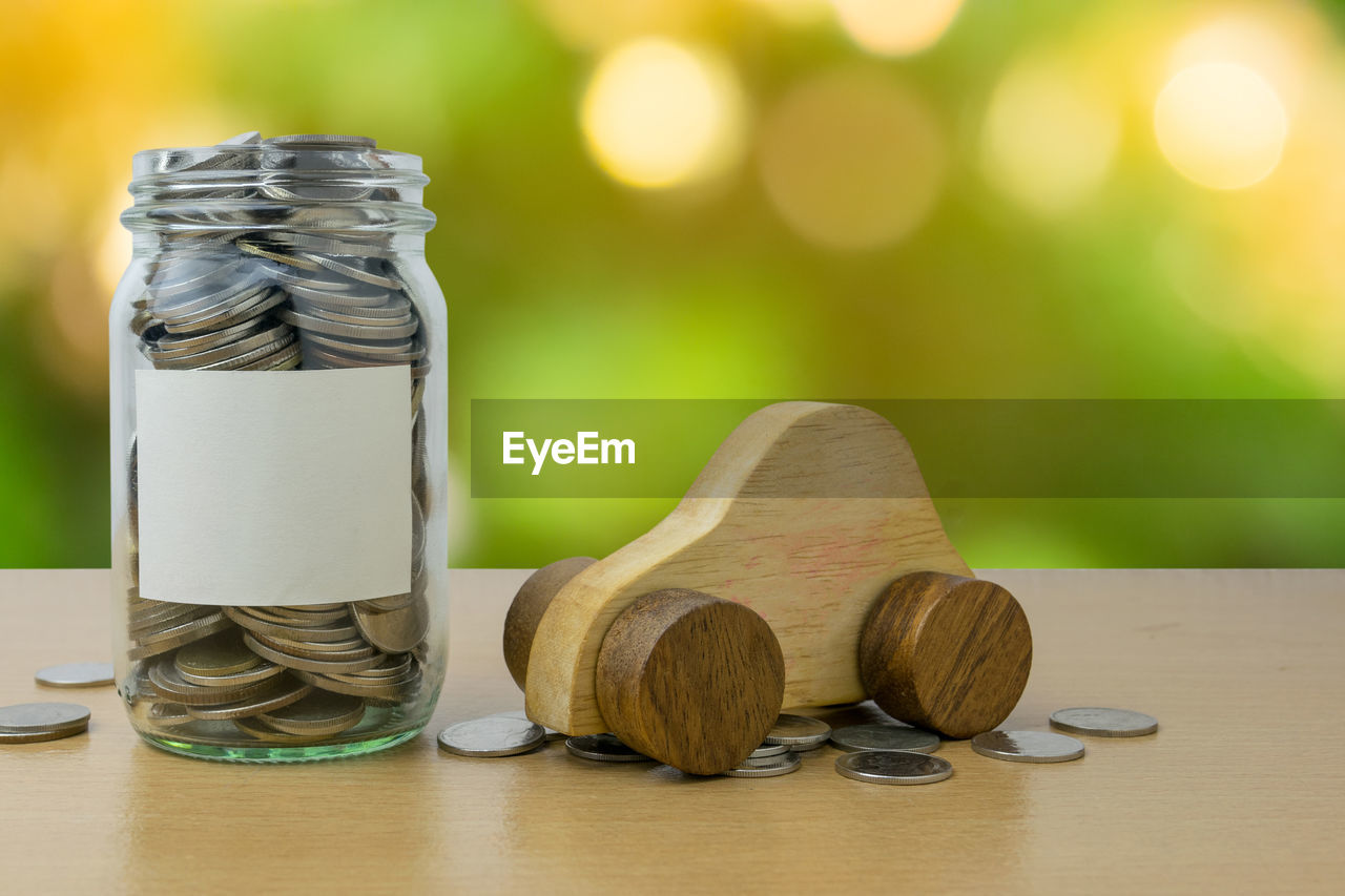 CLOSE-UP OF SHOES IN JAR ON TABLE