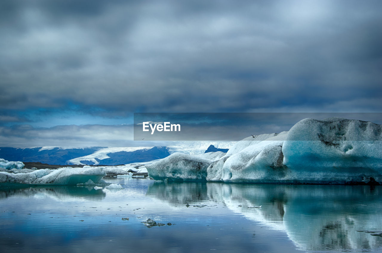 SCENIC VIEW OF LAKE WITH MOUNTAINS IN BACKGROUND