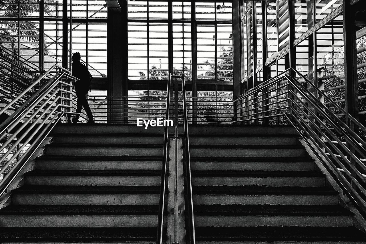 Low angle view of man walking on steps