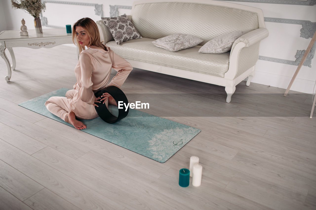 Woman sitting on floor at home