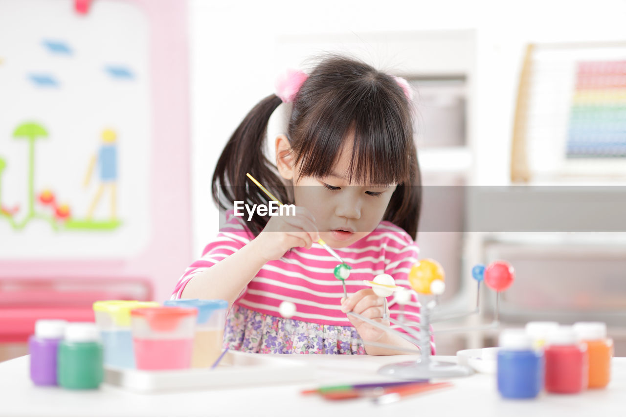 Young girl making craft for homeschooling