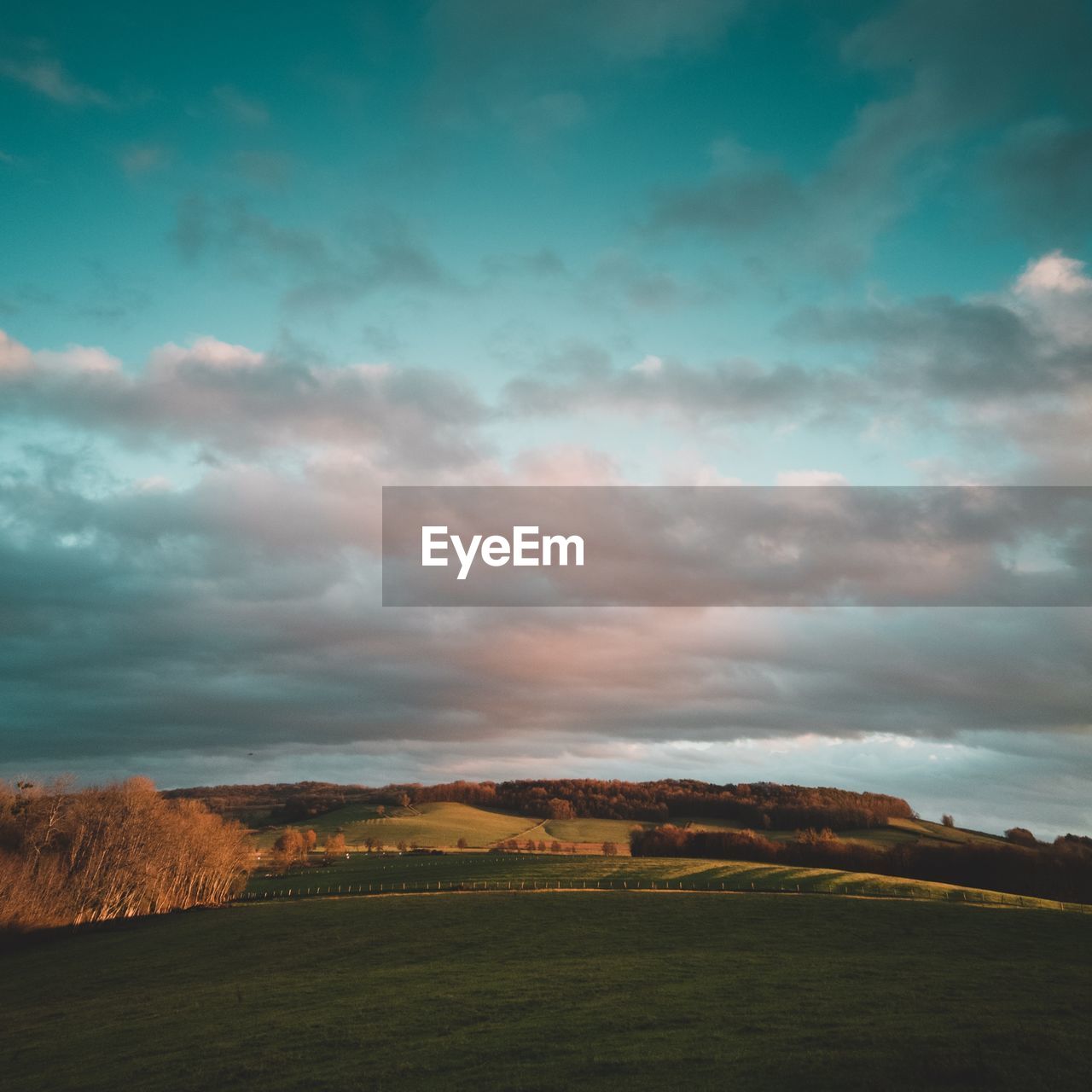 Scenic view of field against sky during sunset