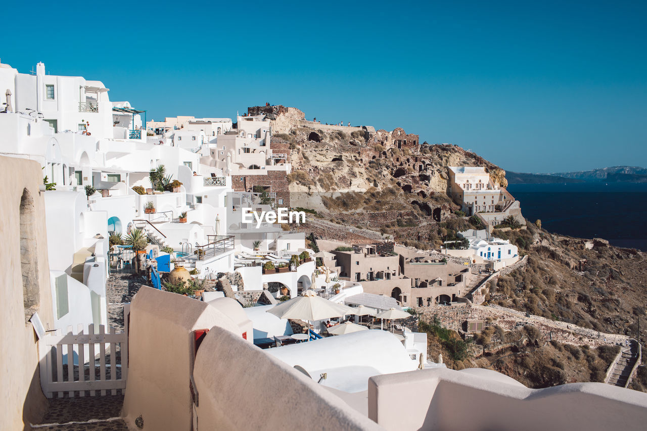 High angle view of townscape by sea against sky