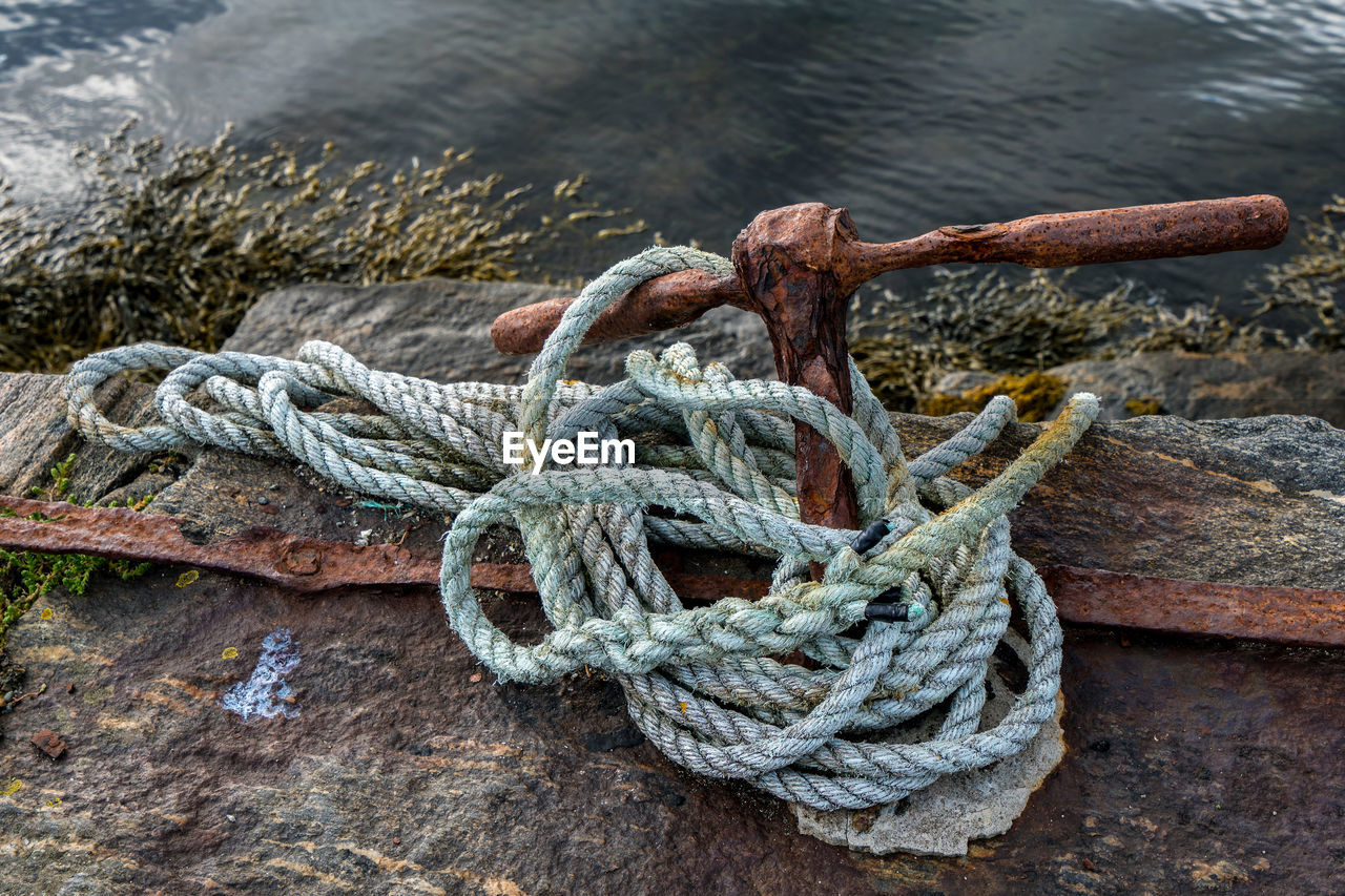 High angle view of rope tied on pier