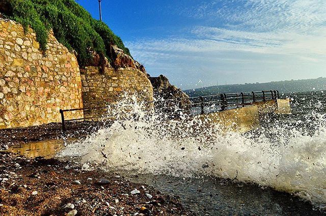 WAVES SPLASHING ON ROCKS