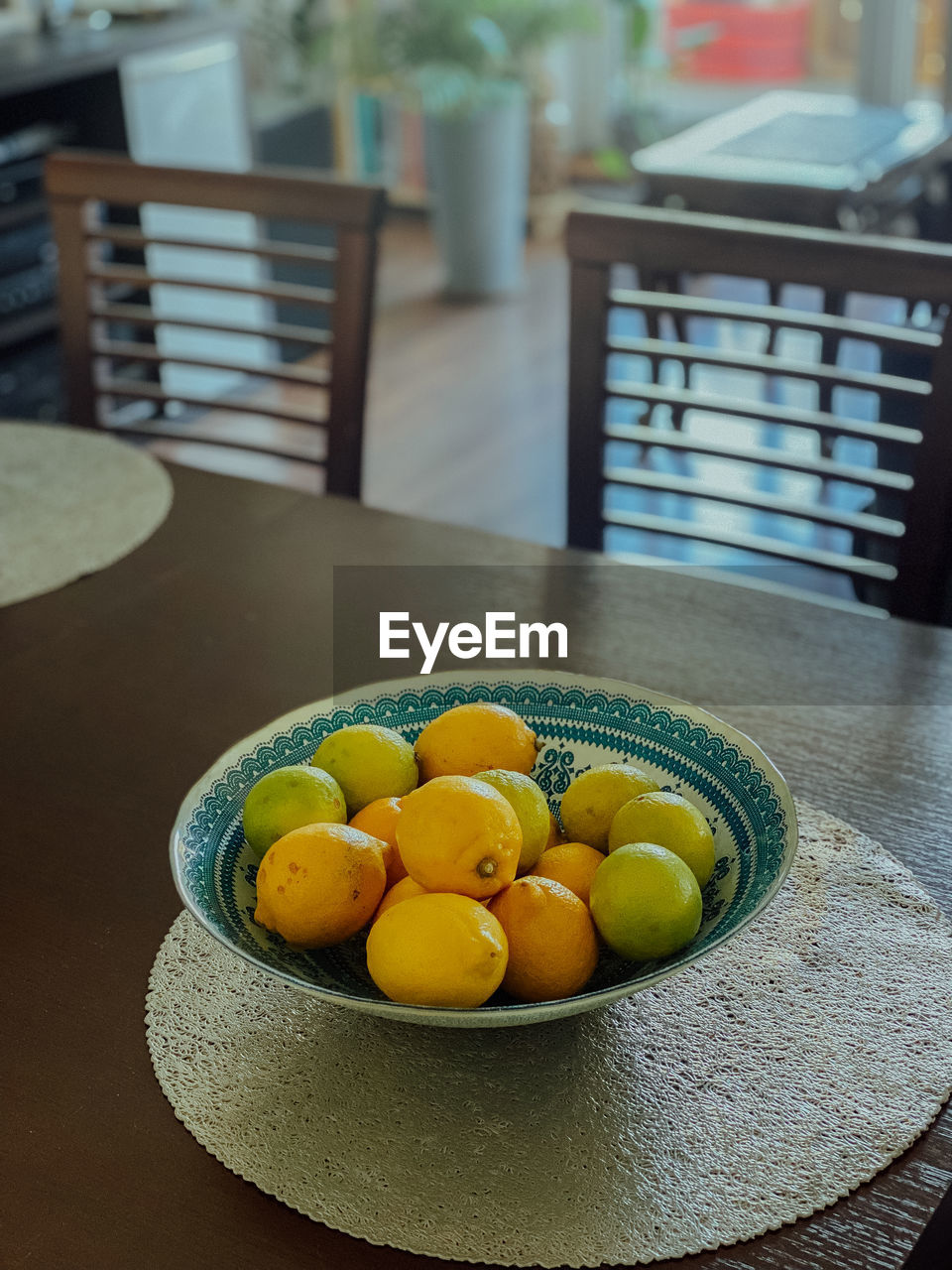 food and drink, food, healthy eating, yellow, table, fruit, wellbeing, freshness, citrus, indoors, no people, plant, furniture, produce, citrus fruit, focus on foreground, bowl, still life, seat, chair, plate, lemon, day, flower, high angle view