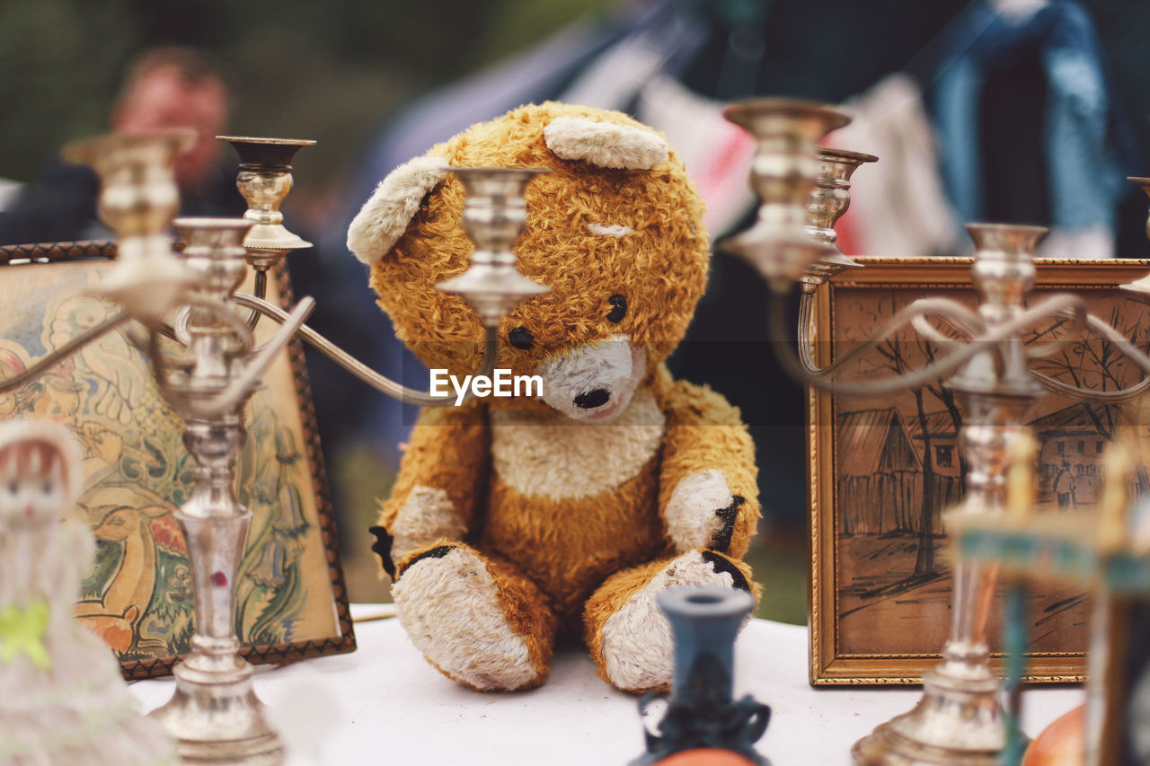 Teddy bear with decorations on table for sale in market