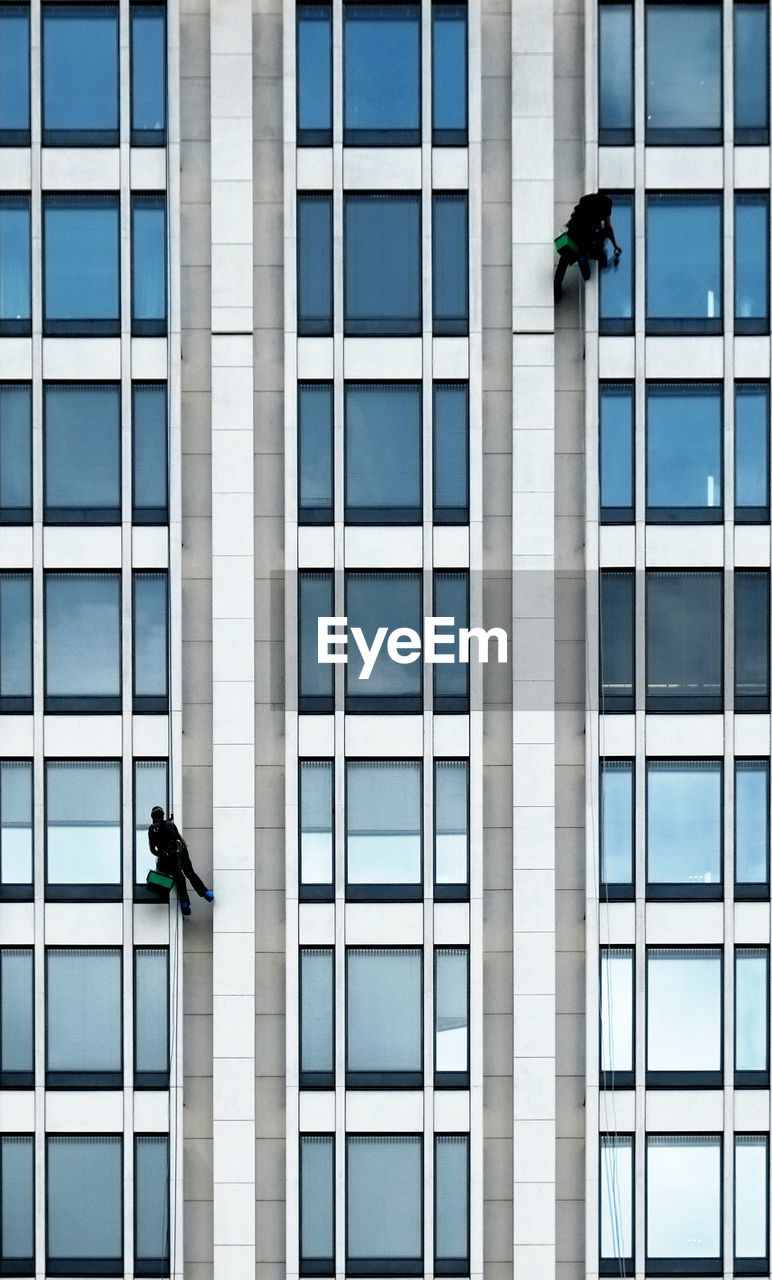 Low angle view of window washers