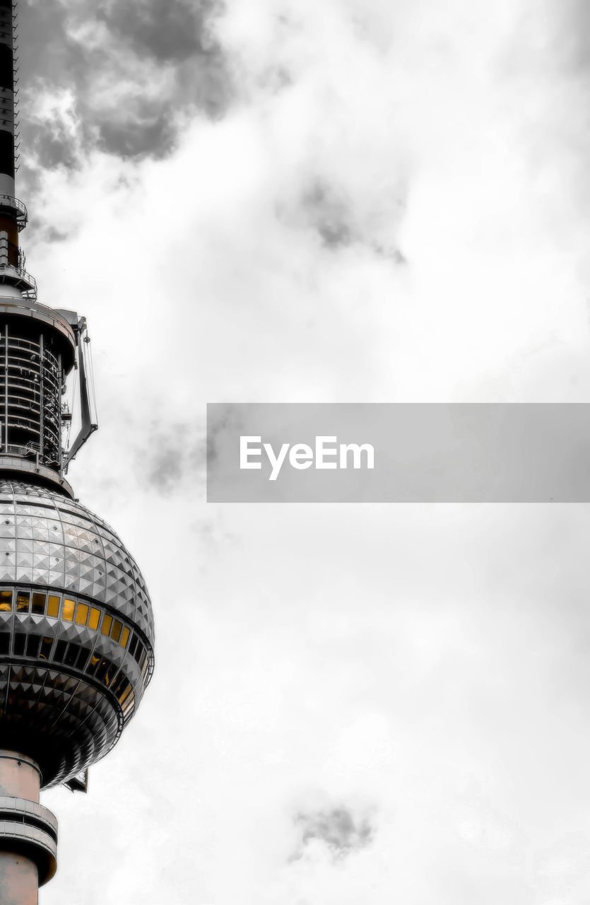 LOW ANGLE VIEW OF TOWER AGAINST CLOUDY SKY