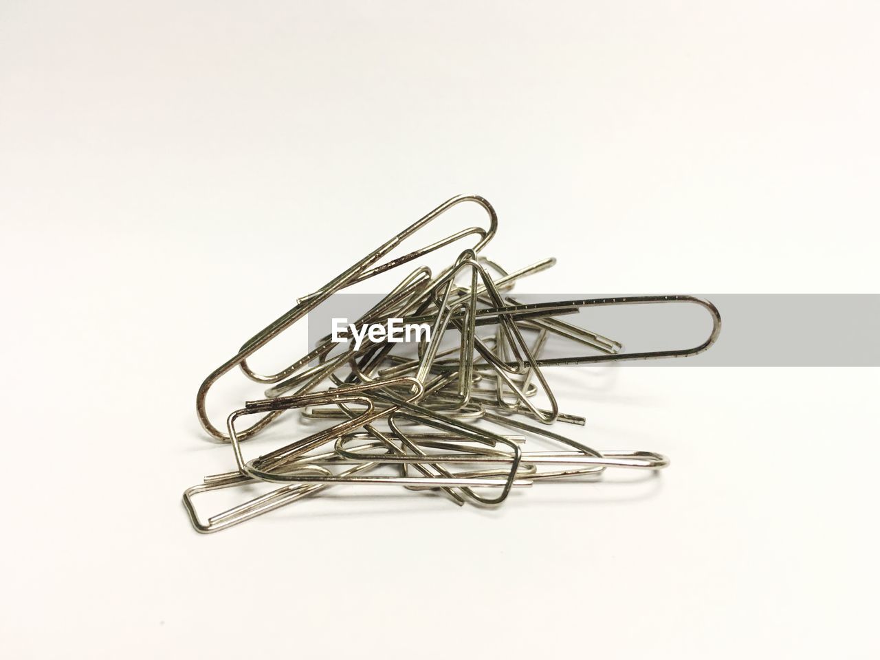 Close-up of paper clips against white background