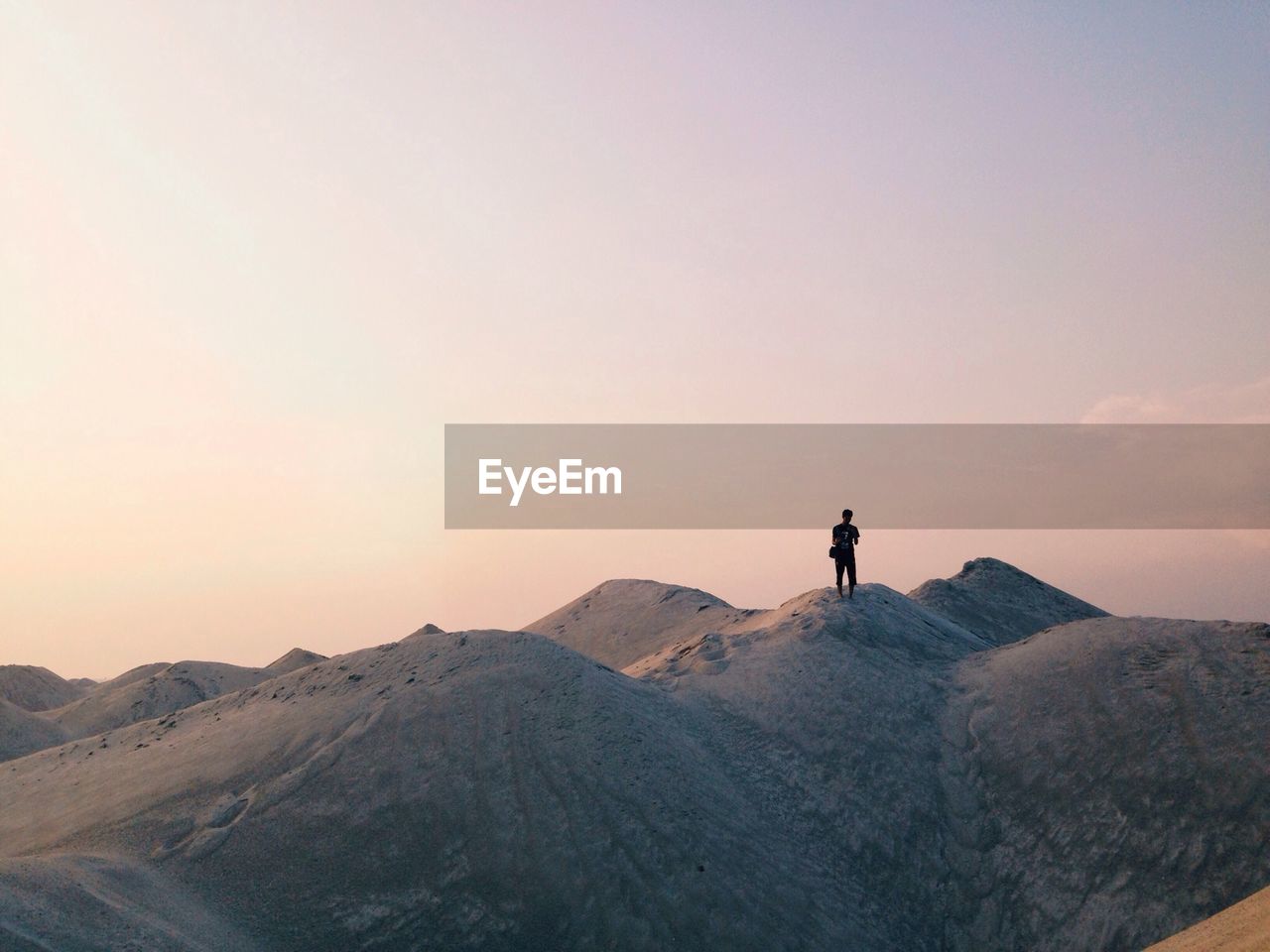 MAN HIKING ON MOUNTAIN LANDSCAPE