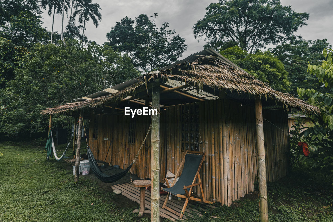 House on field by the caribbean coast against sky