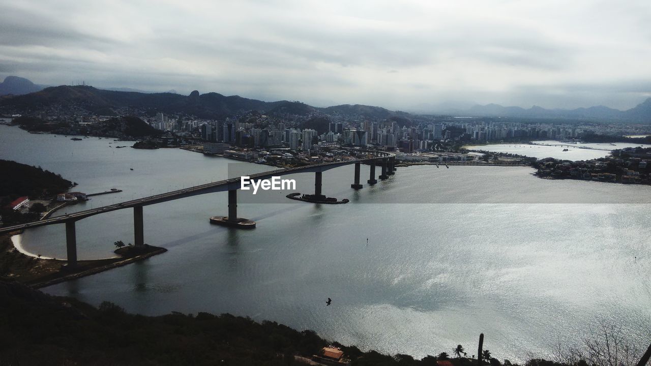 High angle view of city by sea against sky