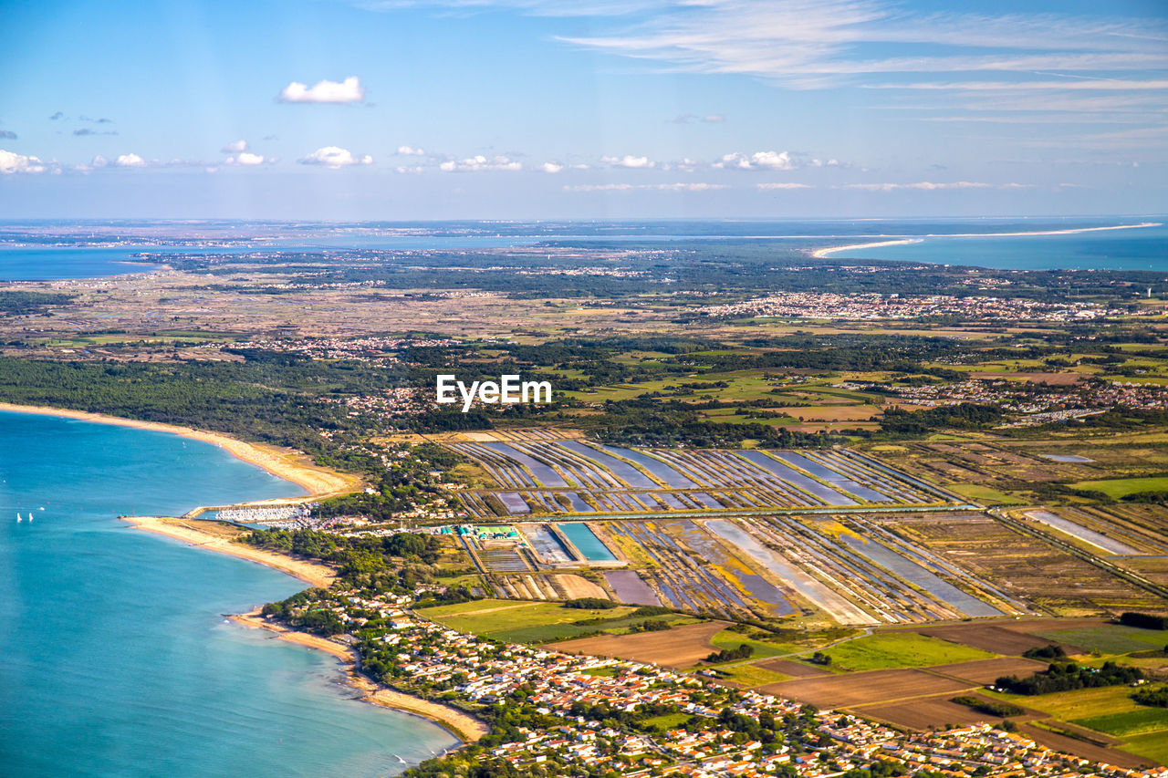 High angle view of sea and cityscape against sky