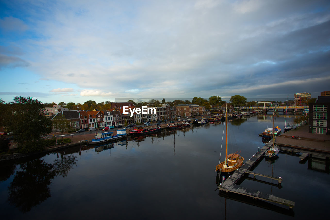 High angle view of river by buildings against sky