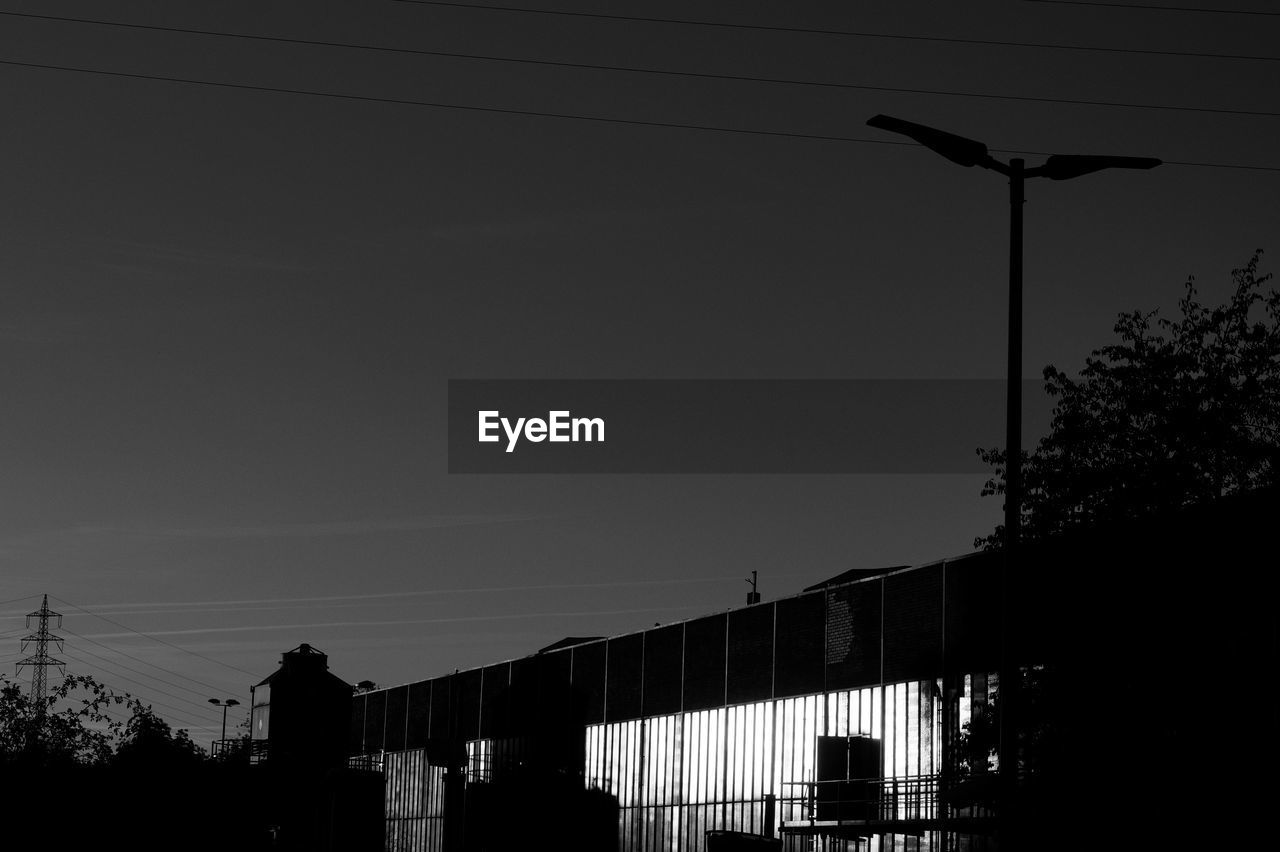 LOW ANGLE VIEW OF STREET LIGHTS AGAINST SKY