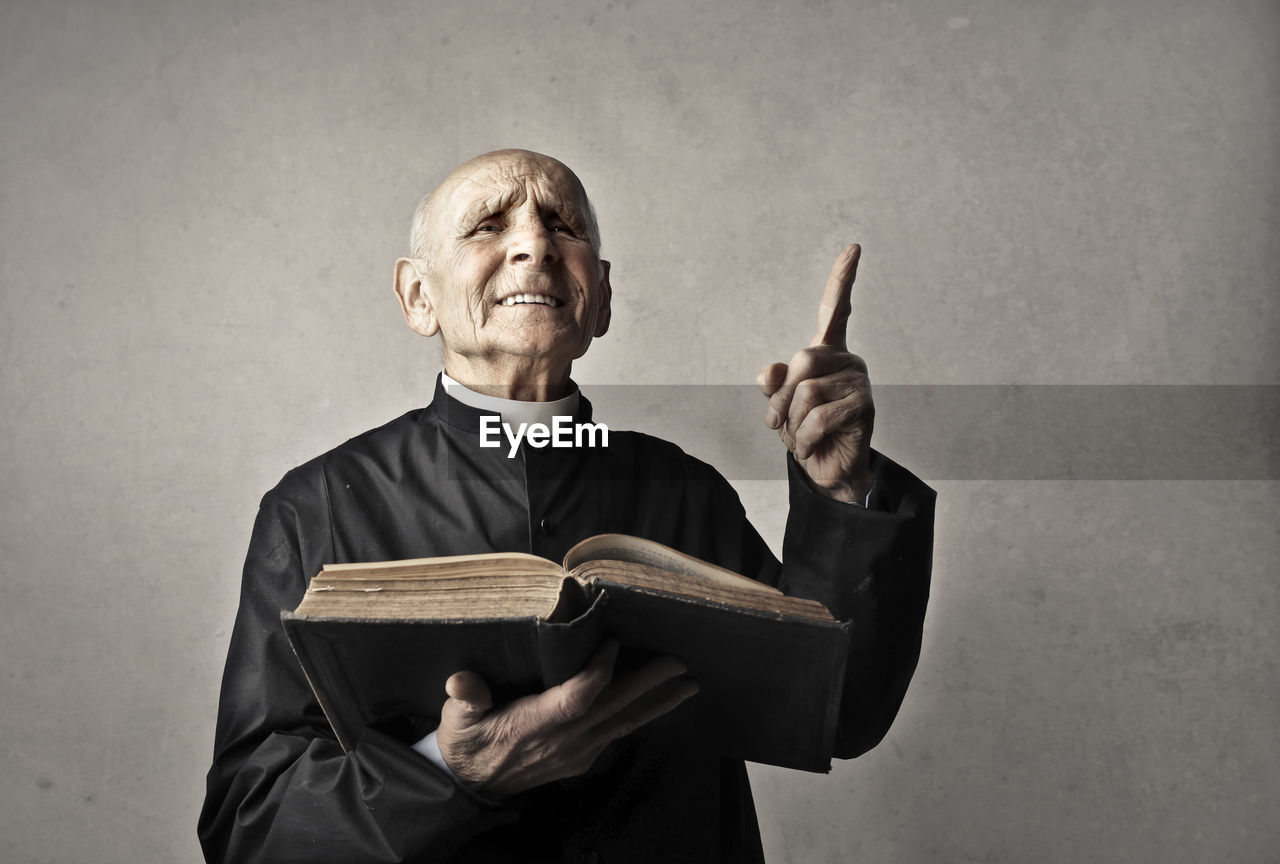 Portrait of priest reciting the gospel