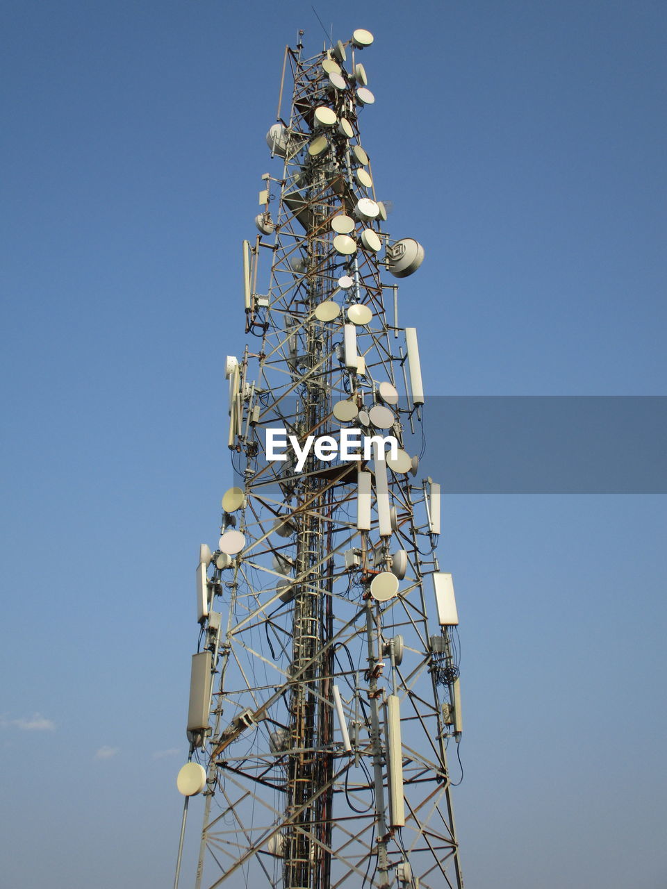 Low angle view of communications tower against sky