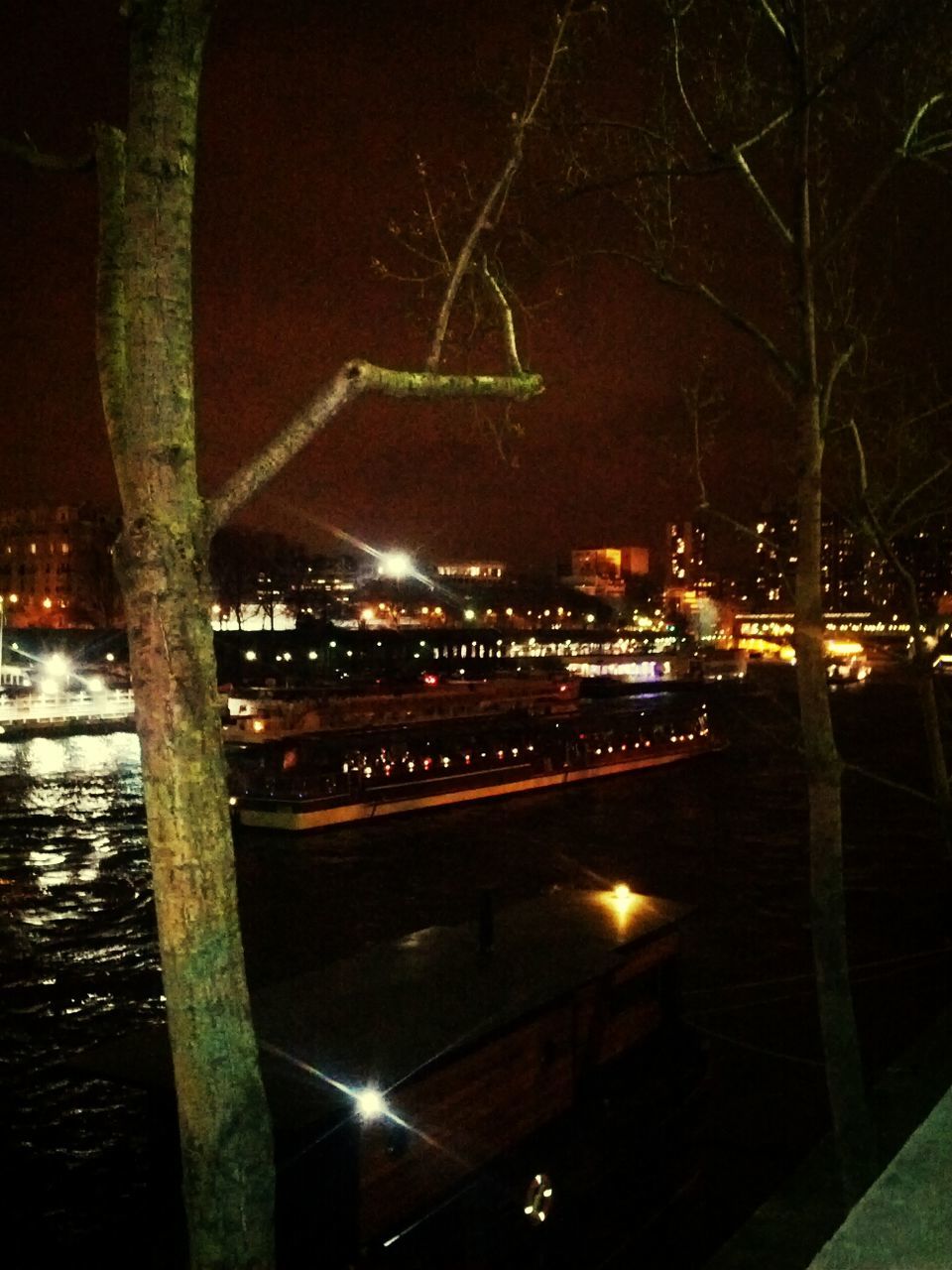 VIEW OF ILLUMINATED CITY AT NIGHT