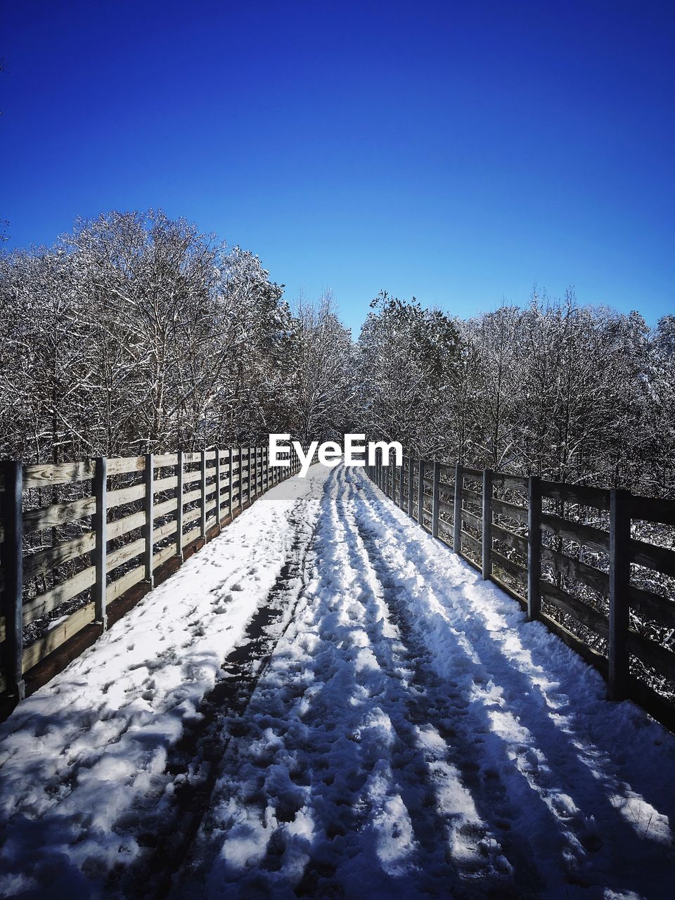 SNOW COVERED FOOTBRIDGE AGAINST CLEAR SKY