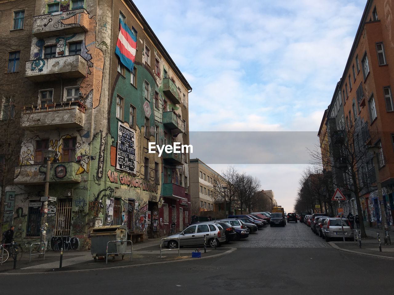 STREET AMIDST BUILDINGS AGAINST SKY