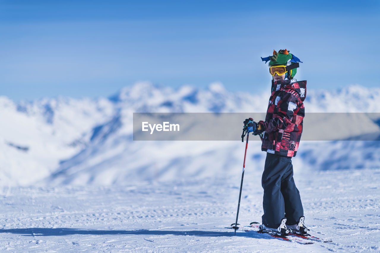 Portrait of boy skiing on snowcapped mountain
