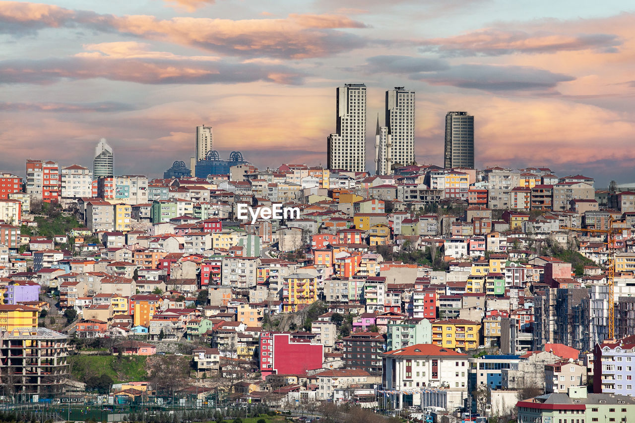 architecture, city, skyline, building exterior, cityscape, urban area, built structure, building, metropolis, metropolitan area, sky, residential district, residential area, neighbourhood, cloud, horizon, landscape, urban skyline, nature, skyscraper, office building exterior, downtown, crowd, tower block, sunset, town, travel destinations, crowded, aerial photography, suburb, outdoors, city life, high angle view, travel, bird's-eye view, environment, transportation, business finance and industry, street, downtown district, house, multi colored, industry