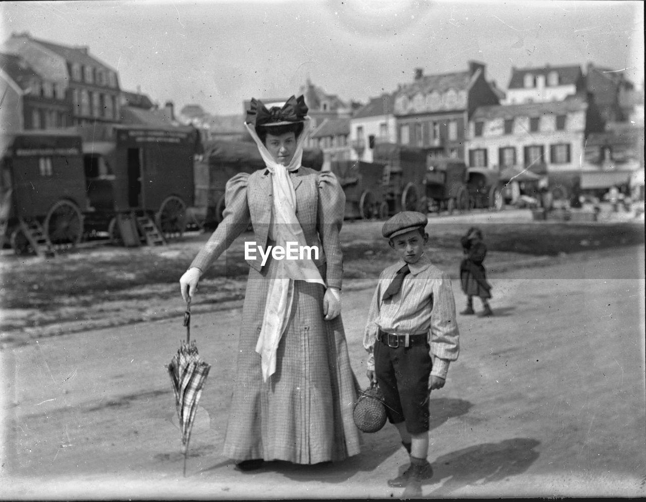 PEOPLE STANDING IN FRONT OF CITY