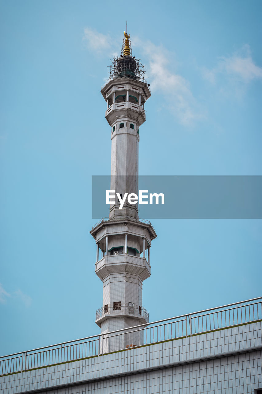 The beautiful asmaul husna tower in the city of kediri with a blue sky background