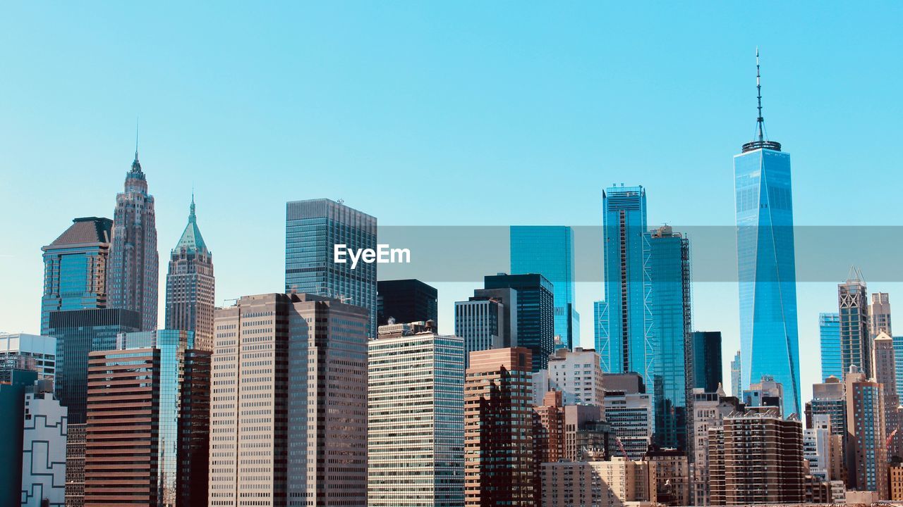 Skyscrapers of lower manhattan against blue sky