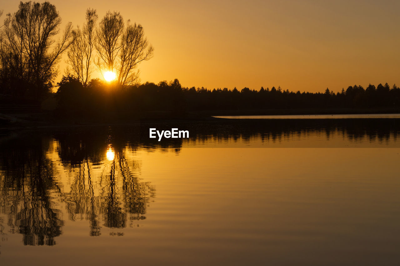 Scenic view of lake against sky during sunset