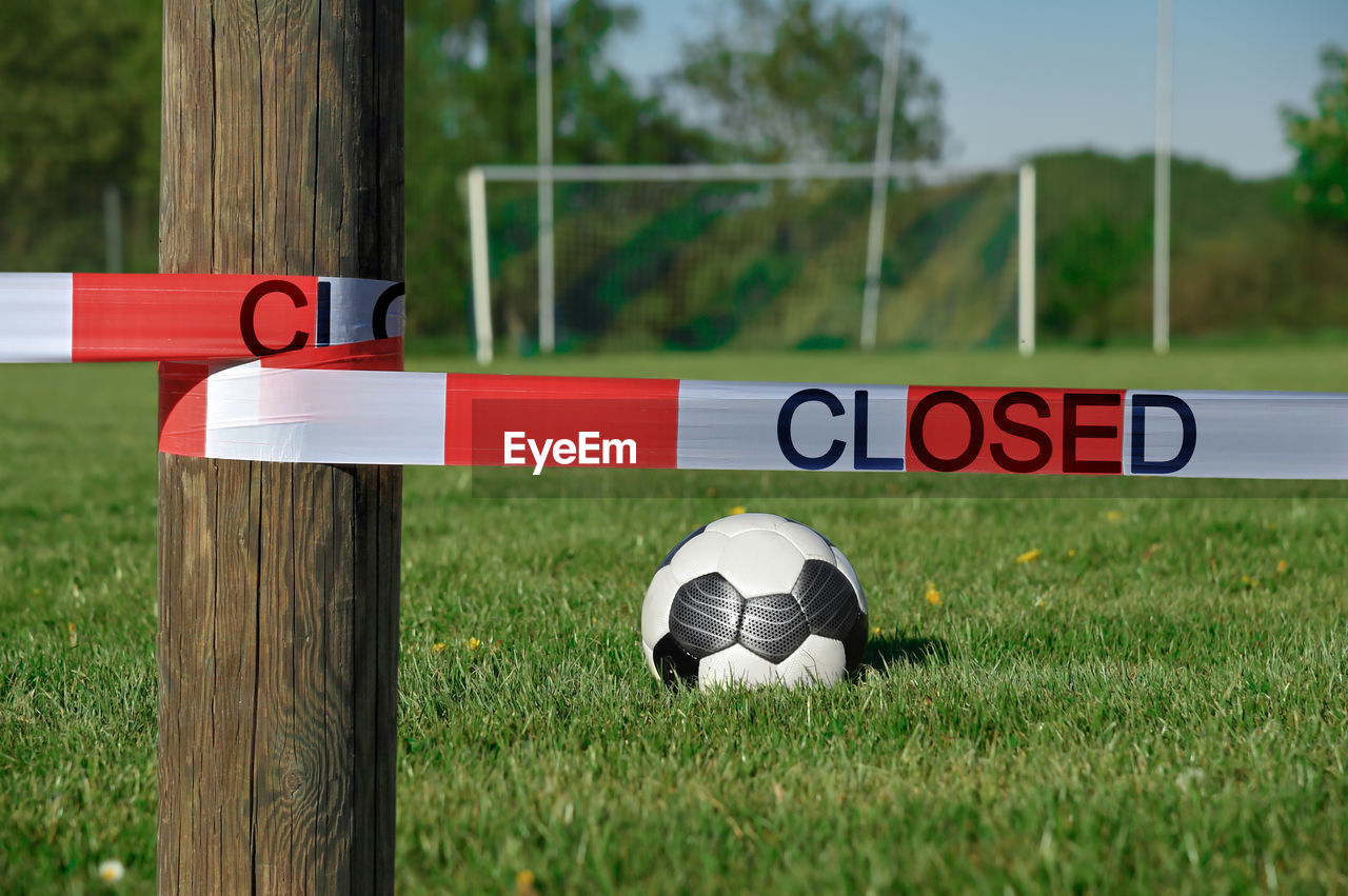 A soccer field is closed with a barrier tape. due to  corona soccer matches have been cancelled. 