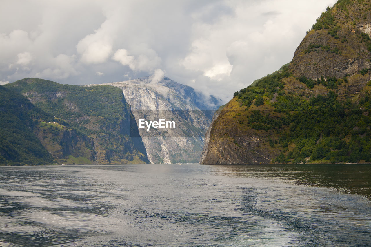 Scenic view of sea and mountains against sky