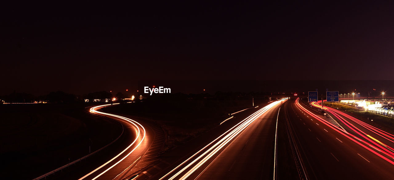 High angle view of light trails on highway at night