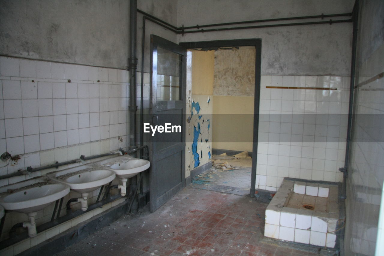 Sinks in abandoned public restroom