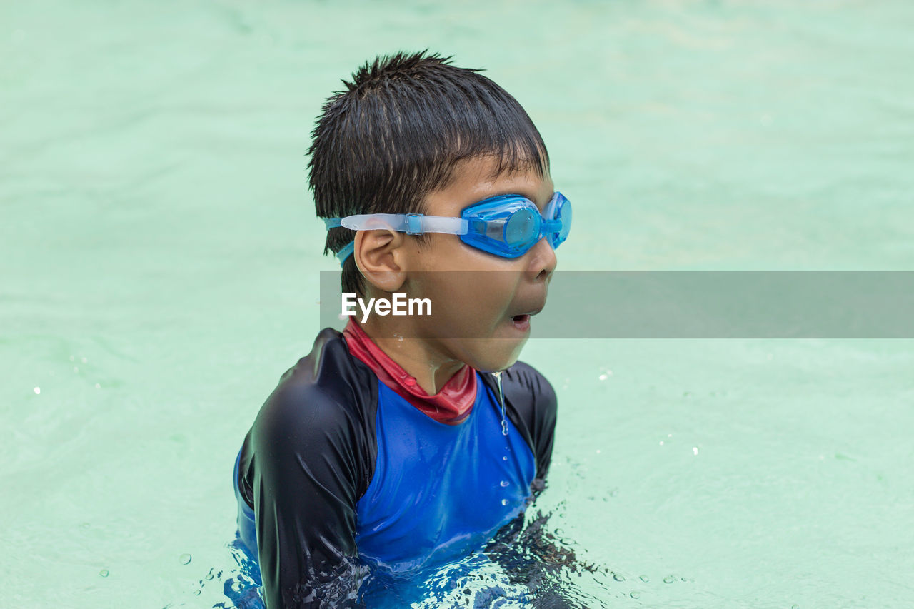 Boy swimming in pool